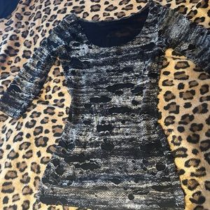A black “ripped up” mini dress, that can be used as a top